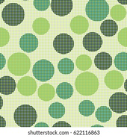 Seamless pattern. Front of small circles positioned in straight rows. The background of the larger circles arranged in a random order.  White and green.