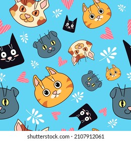 Seamless pattern with funny cats. Cartoon style. Vector on a blue background.