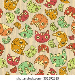 Seamless pattern. Funny cute cats faces. Beije background, warm colors.