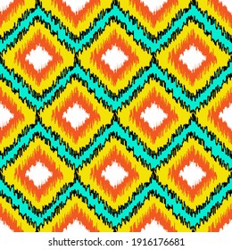 Seamless pattern with geometric ornament in Ikat style. Orange, yellow elements on blue background. Good print for wrapping paper, packaging design, wallpaper, ceramic tiles, and textile