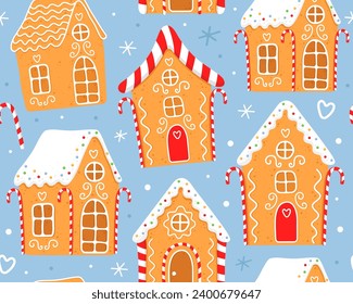 Seamless pattern with gingerbread houses on a blue background. Gingerbread houses with white sugar glaze. Red white striped christmas candles. Design for wrapping paper, fabric, textile, decor.