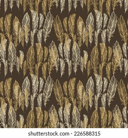 Seamless pattern with golden - beige  feathers on brown background