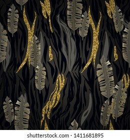 Seamless pattern of golden, black tropical leaves and stripes of a tiger, zebra.
