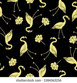 Seamless pattern with golden flamingos and lotuses on a black background.