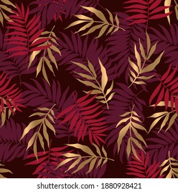 Seamless pattern with golden and red tropical leaves on deep red background. Vector illustration. Fabric print. 