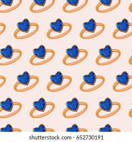 Seamless pattern with golden rings and blue heart shaped gemstone