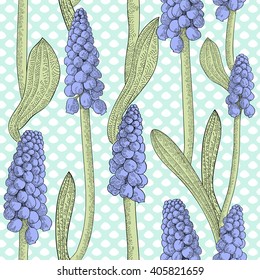 Seamless pattern with grape hyacinth, or muskari, on blue uneven dotted background. Vector illustration.