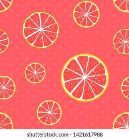 Seamless pattern grapefruit on a polka dot coral background.