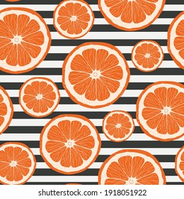 Seamless pattern with grapefruits. Yellow citrus slices on a striped background. Citrus fruit. For wrapping paper and fabric prints. Vector stock illustration.