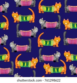 Seamless pattern. Gray and red cats in blankets on a dark blue background