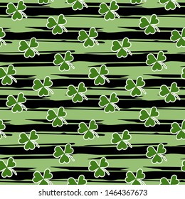 Seamless pattern with green clover on grunge stripes