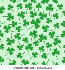Seamless pattern with green clover  the symbol of St. Patrick's day. Vector  illustration with shamrock symbol of Ireland, hand drawn in doodle  on color background for design, kids decor, wrapping