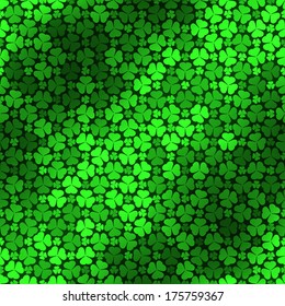 Seamless pattern with green clovers, vector background