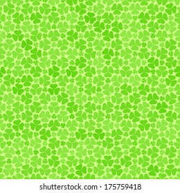 Seamless pattern with green clovers, vector background