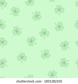 Seamless pattern 
with green leaves of clover on a green background. Suitable for congratulations to the St. Patrick's day, cards, patterns, logos, textiles, packaging.