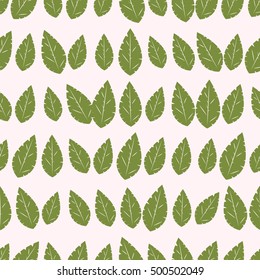 Seamless pattern of green leaves on a beige background. Vector image of leaves.