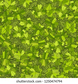 Seamless pattern. Green maple leaves on the background of the parquet pattern. Camouflage style.