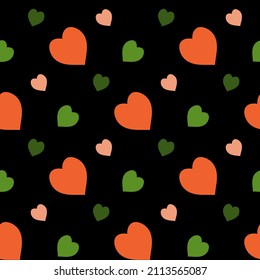 Seamless pattern with green and orange hearts on black background. Vector image.
