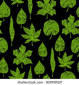 seamless pattern with green ornamental leaves on the black background