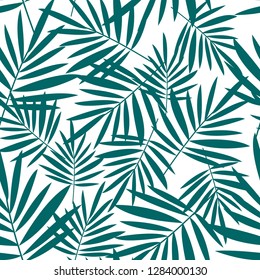Seamless pattern with green palm leaves on awhite background. Tropical background.