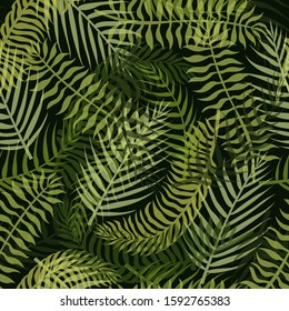 Seamless pattern with green tropical leaves on the dark background.