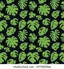 Seamless pattern with green tropical leaves on black background. Monstera leaves silhouette pattern.