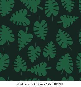 Seamless pattern with green tropical monstera leaves on a dark background. Vector.