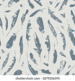 Seamless pattern with grey feathers on a beige backdrop. Vector repeatable background with bird plumes. Suitable for wallpaper, wrapping paper, textile, fabric