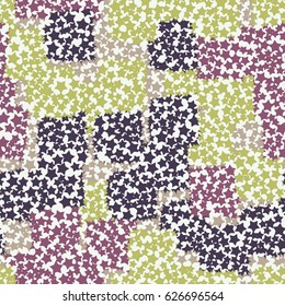 Seamless pattern. A grid of holes in the form of five-pointed stars. The background of randomly scattered spiked squares.  Green, white, beige, purple, pink.