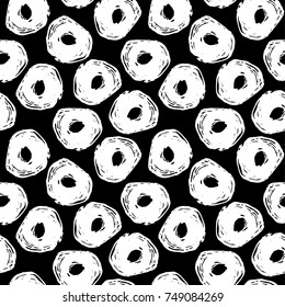 Seamless pattern with grunge circle on a black background. Abstract vector background.