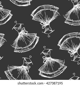 Seamless pattern hand drawing with white contour of women's dresses on the black background