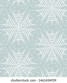 Seamless pattern. Hand drawn abstract winter snowflakes. Stylish crystal stars on cream background. Elegant boho holiday all over print. 