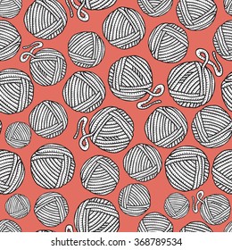 Seamless pattern with hand drawn balls of yarn on orange background. Background in cartoon style.