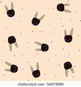 Seamless pattern with hand drawn bunny and dots on light peach background 