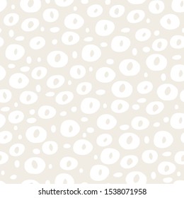 Seamless pattern with hand drawn circles and dots on a beige background. Vector illustration.