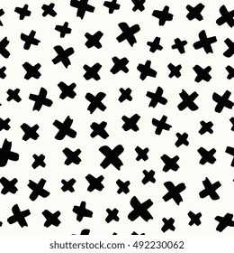 Seamless pattern with hand drawn crosses in black on cream background.