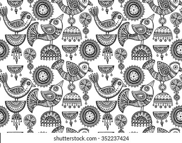 Seamless pattern with hand drawn fancy birds in ethnic ornate doodle style with jewelry elements. Black and white vector background.