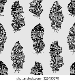 Seamless pattern with hand drawn feathers. Vector background.