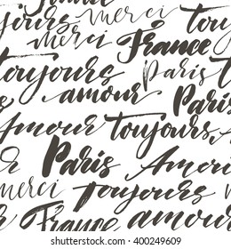 Seamless pattern with hand drawn french words. Modern brush calligraphy. Isolated on white background. Paris, France, toujours amour, merci, bonjour. Always love, thank you and hello in french.