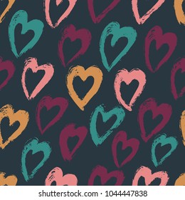 Seamless pattern with hand drawn heart on a dark background. Hearts painted dry brush. 
