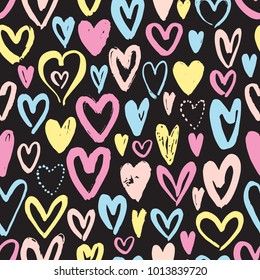 Seamless pattern with hand drawn hearts on black background. Vector illustration.