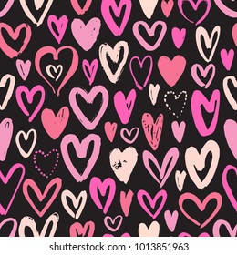 Seamless pattern with hand drawn hearts on black background. Vector illustration.