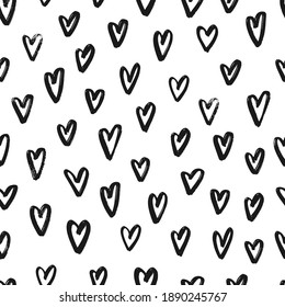 seamless pattern with hand drawn hearts on white background for Valentine's day decor. Black brush strokes on white background for wrapping paper, textile prints, packaging, etc. EPS 10