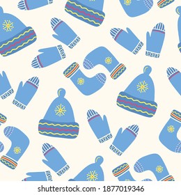 Seamless pattern with hand drawn knitted hat, mittens and socks on a beige background. Doodle, simple illustration. It can be used for decoration of textile, paper and other surfaces.