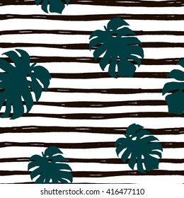 Seamless pattern. Hand drawn monstera deliciosa leaves on striped background