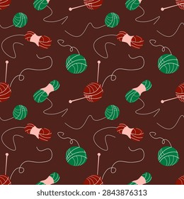 Seamless pattern of hand drawn red and green balls of yarn, skeins, knitting needles, and swirling threads on dark chocolate brown background. Ideal for cozy craft themed textiles and surface design.