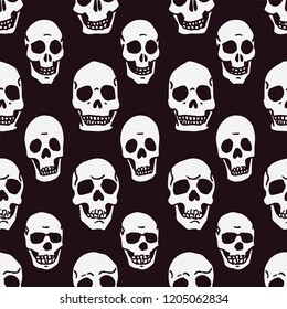 Seamless pattern of hand drawn skulls on black background