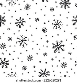 Seamless pattern with hand drawn snowflakes.  Black and white vector doodle sketch.