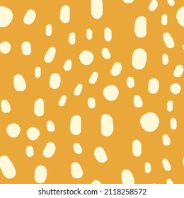 Seamless pattern with hand drawn spots. Pastel doodle illustration on a beige background. Vector background with animal print cute blots.