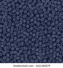 A seamless pattern with hand drawn stars on indigo blue background.